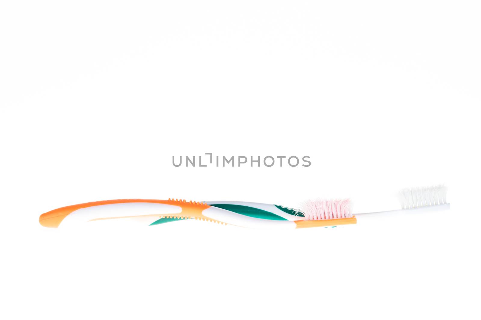 Two Color worn toothbrush on white background