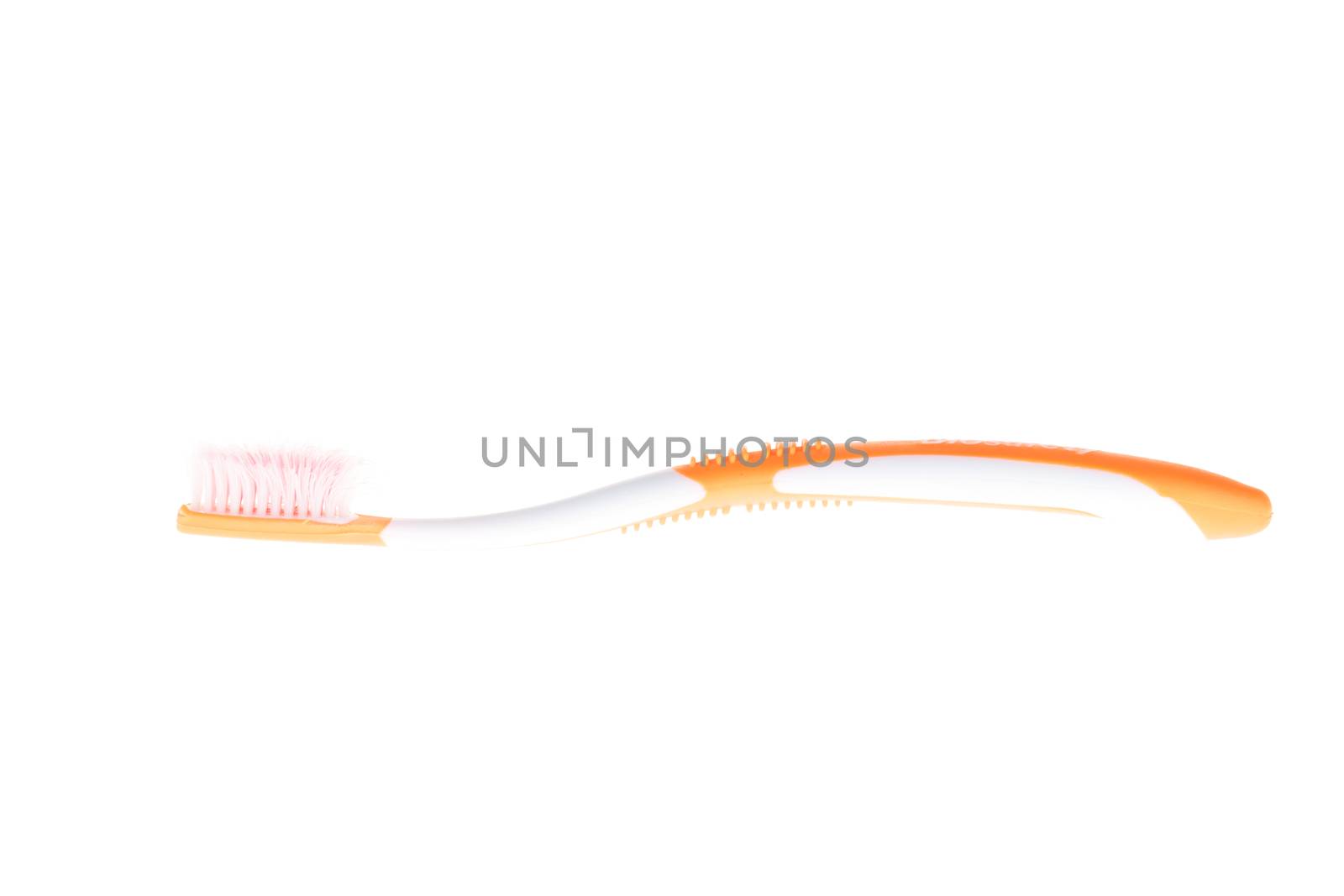 Orange worn toothbrush on white background