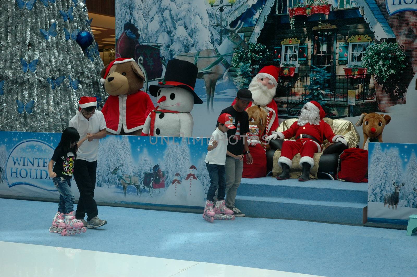 bandung, indonesia-december 17, 2011: girl and boy learning inline skate at bandung supermall venue.