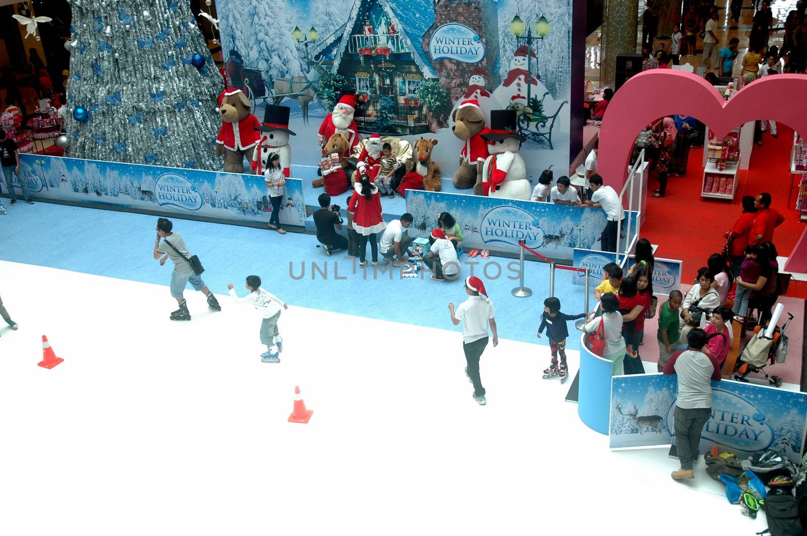 bandung, indonesia-december 17, 2011: girl and boy learning inline skate at bandung supermall venue.