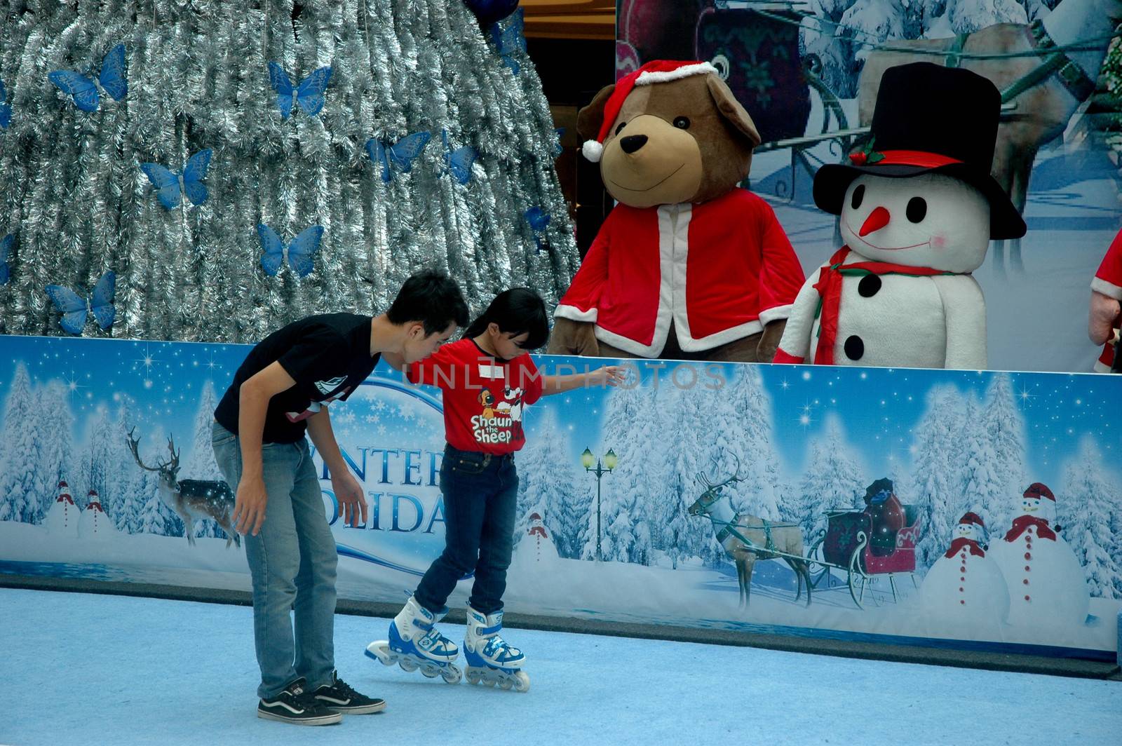 bandung, indonesia-december 17, 2011: girl learning inline skate at bandung supermall venue.