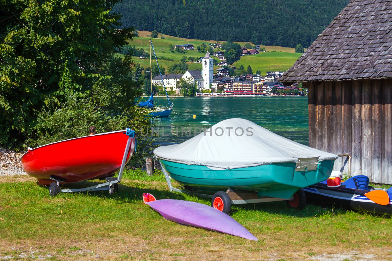 View of St. Wolfgang village waterfront at Wolfgangsee lake with beach toys in front, Austria