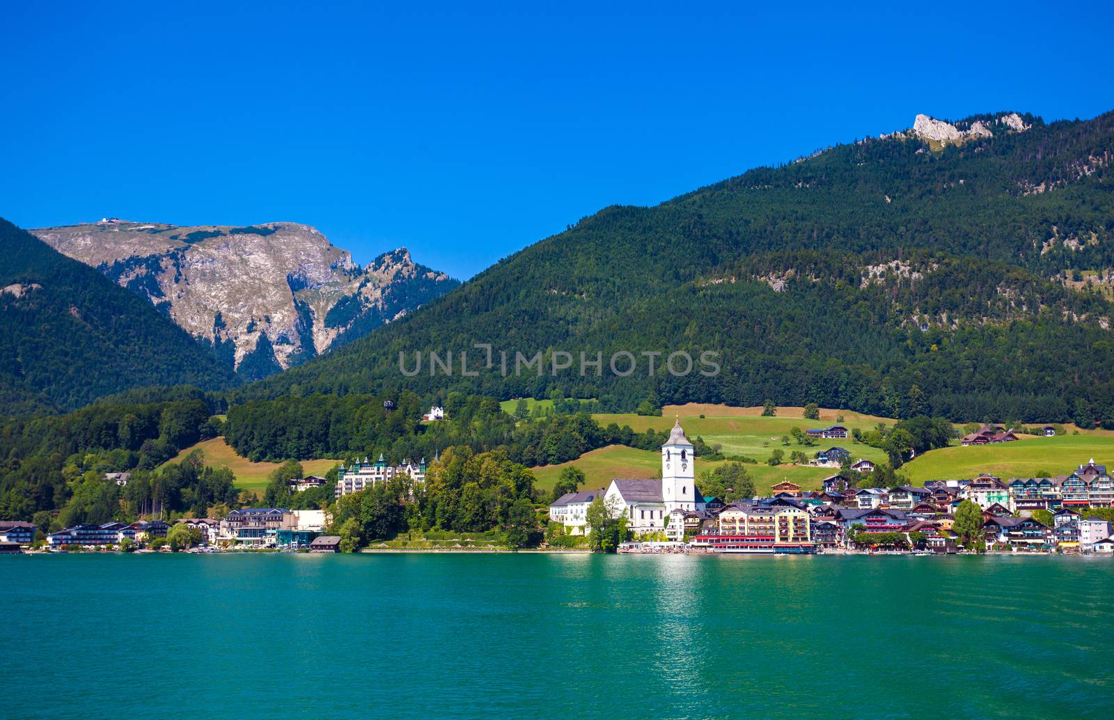 View of View of St. Wolfgang chapel and the village waterfront at Wolfgangsee lake, Austria