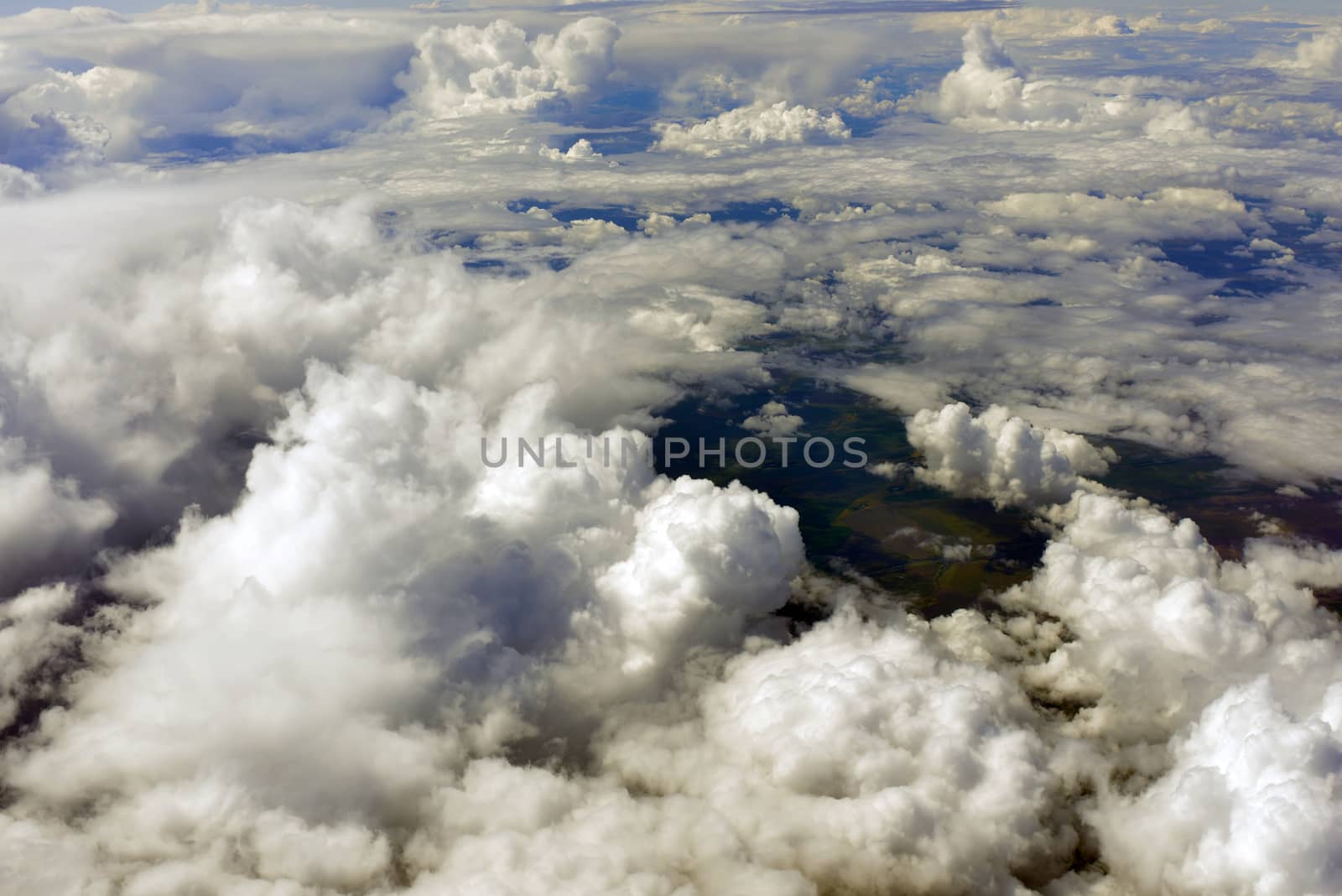 Blue sky and clouds. Top view of aircraft