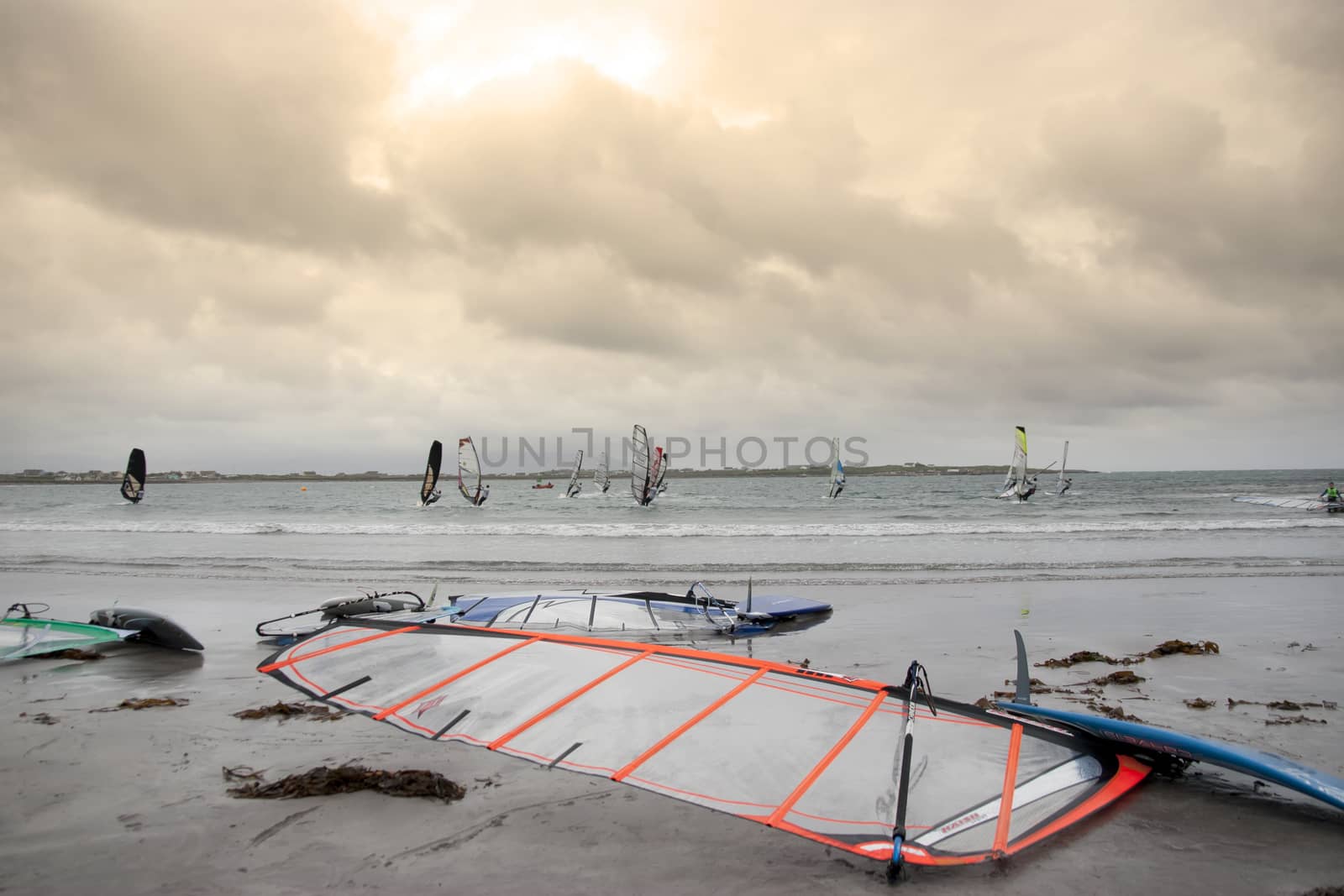 wind surfers racing in the storm winds on the wild atlantic way in county Kerry Ireland
