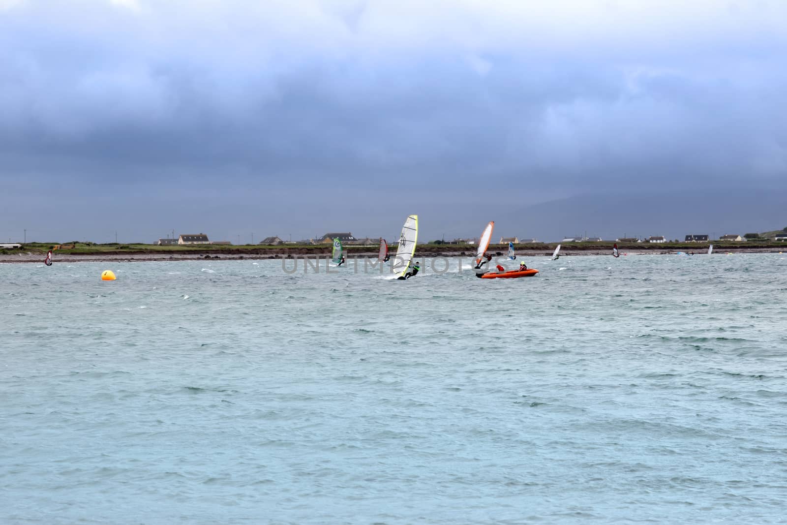 wind surfers racing in the storm winds on the wild atlantic way in county Kerry Ireland