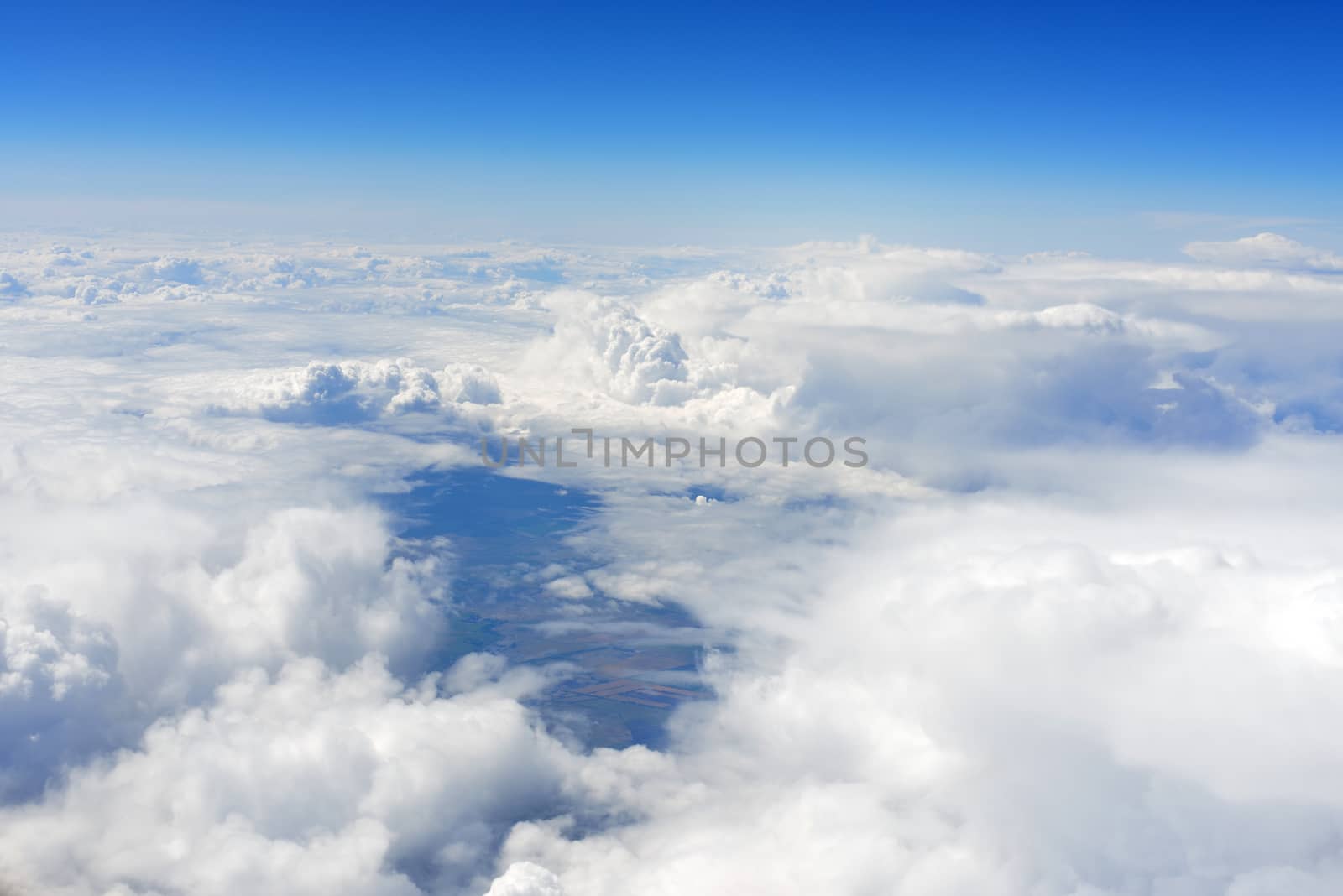 Blue sky and clouds. Top view of aircraft