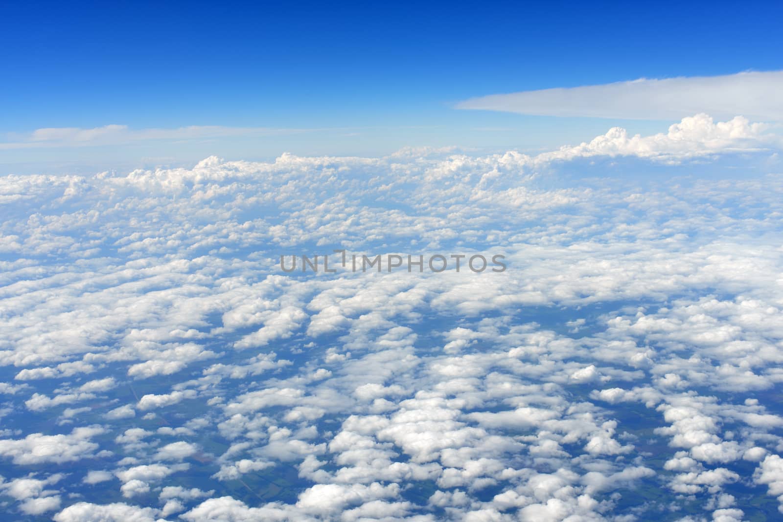 Blue sky and clouds. Top view of aircraft