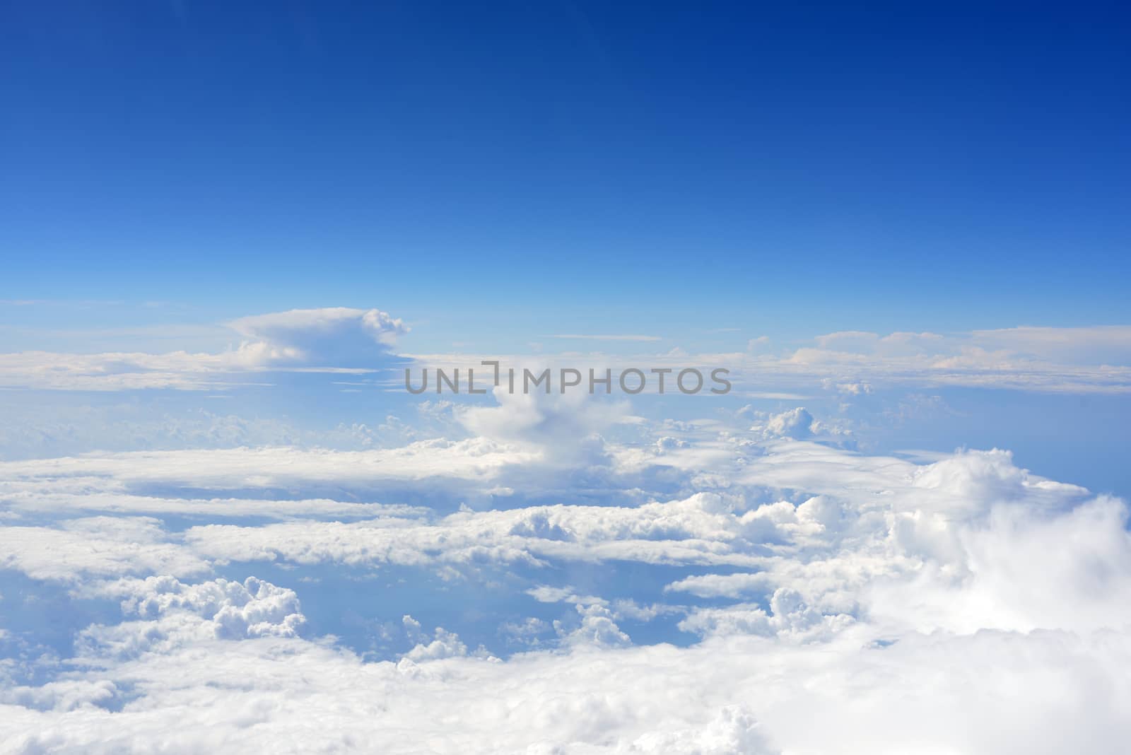 Blue sky and clouds. Top view of aircraft