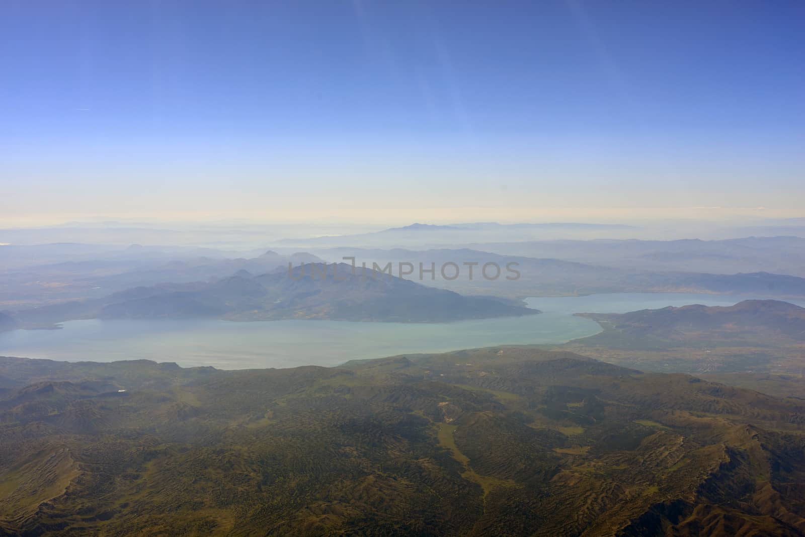 View from the plane on mountain, river and sky