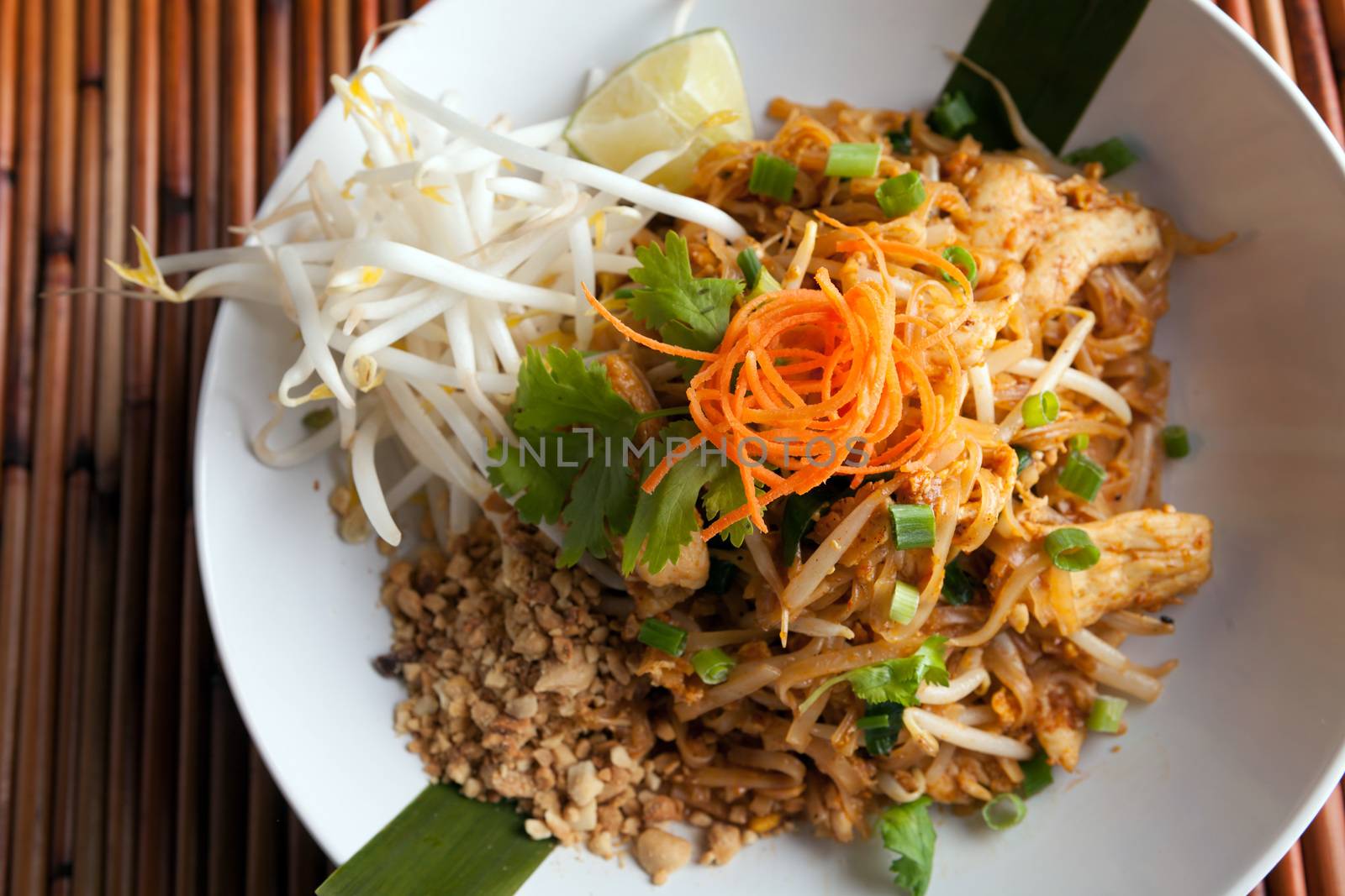 Chicken pad Thai dish of stir fried rice noodles with a contemporary presentation.