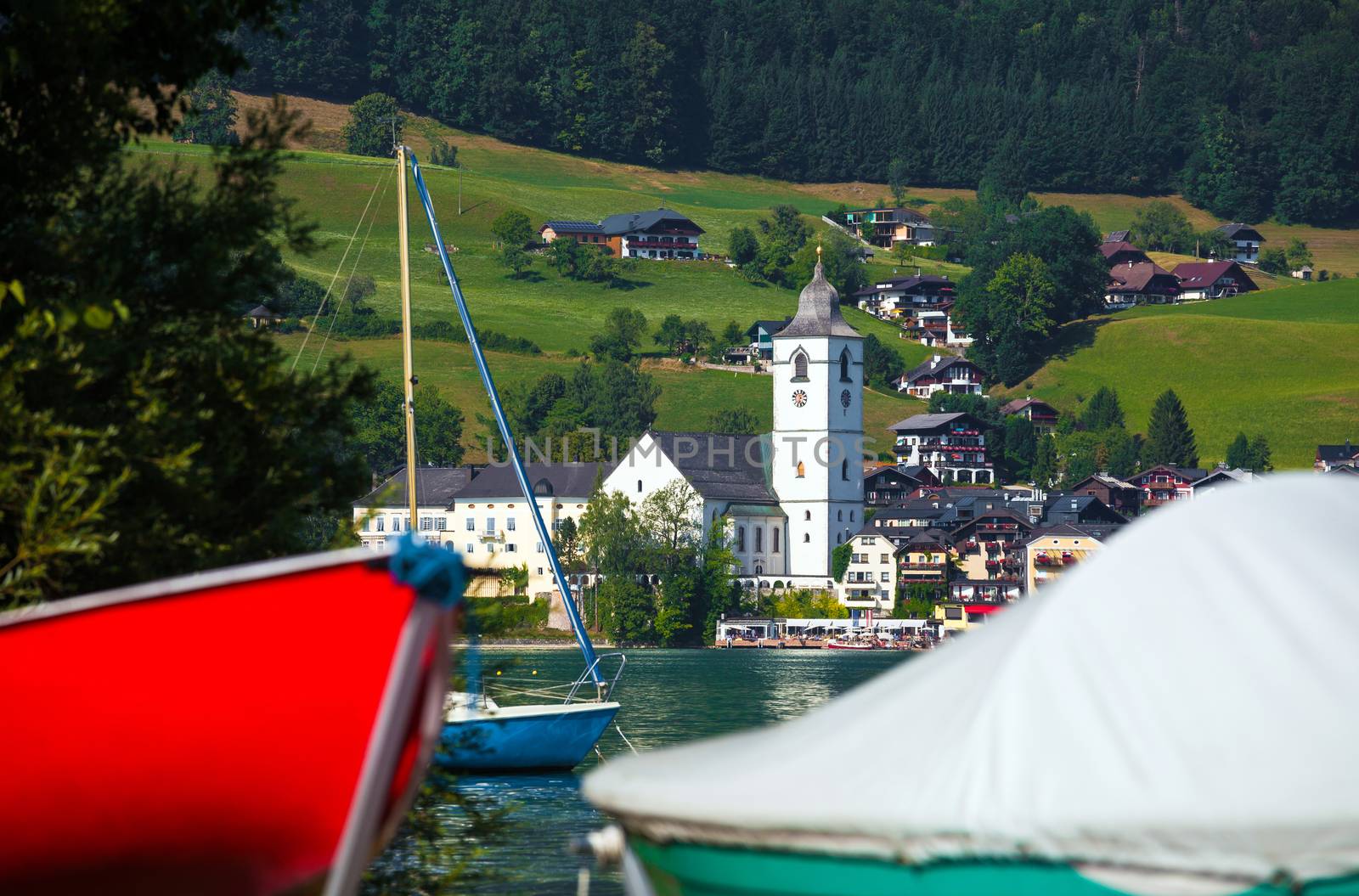 View of St. Wolfgang village waterfront at Wolfgangsee lake with beach toys in front, Austria