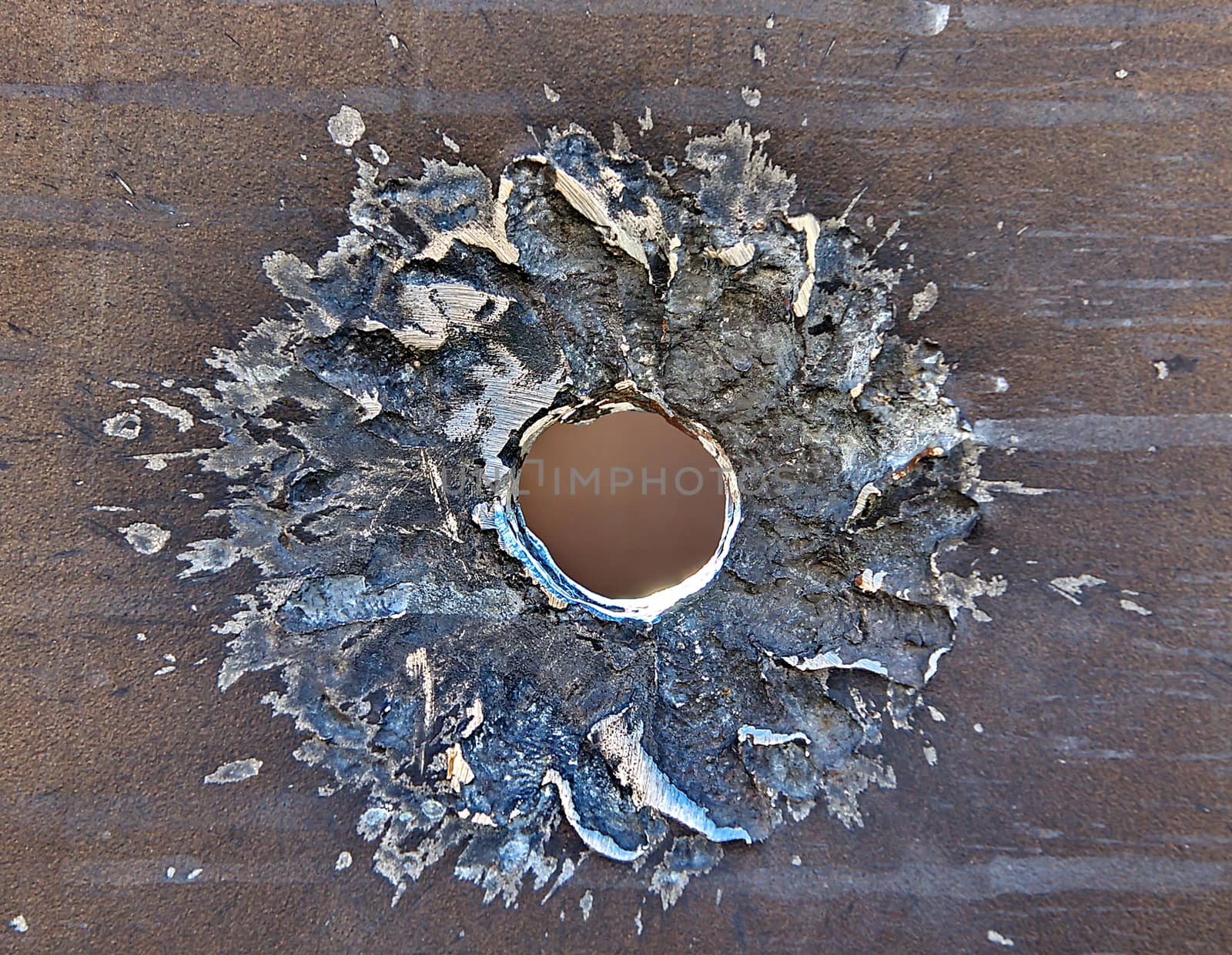 Bullet hole on iron surface