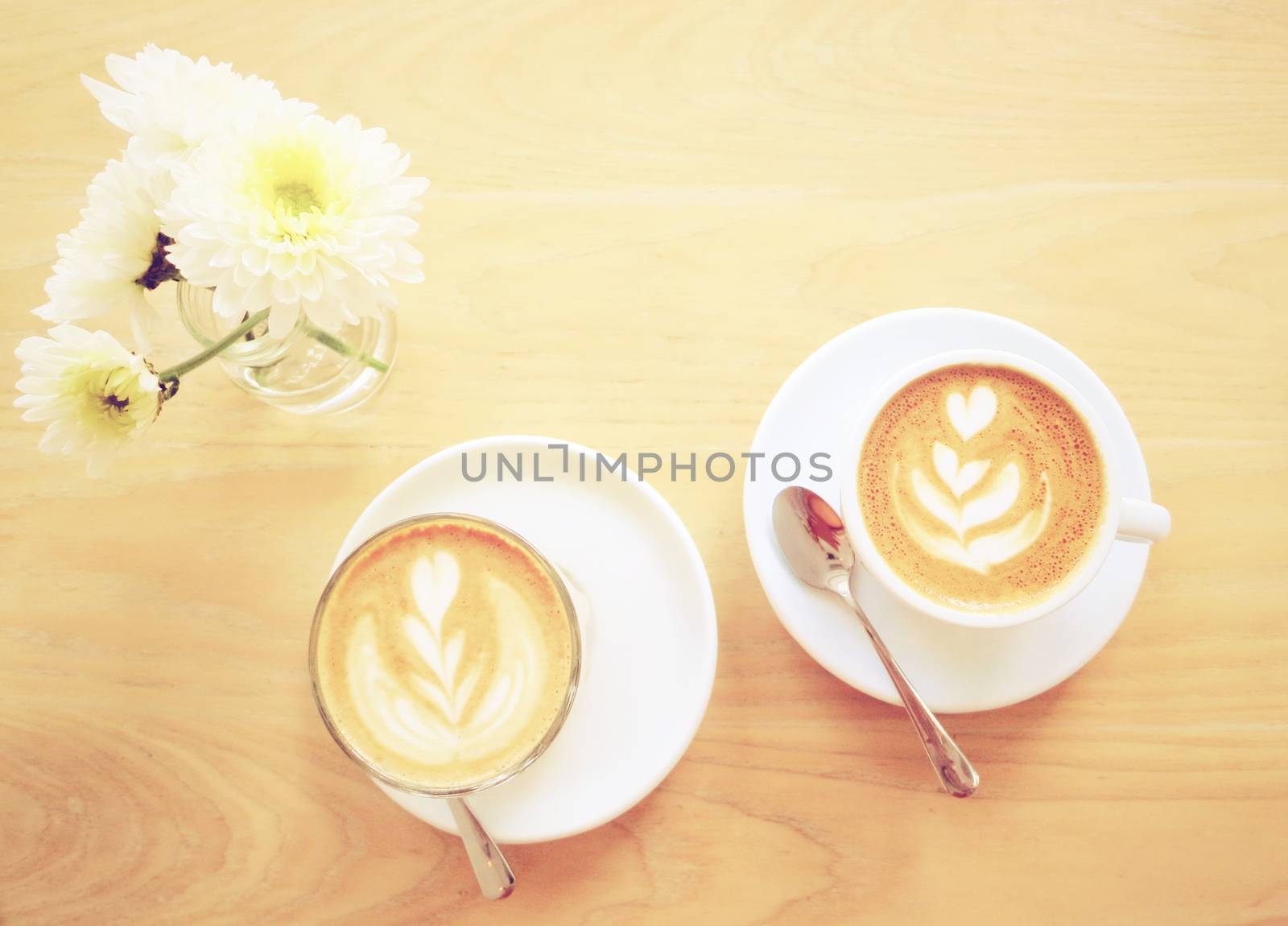 Cup of latte or cappuccino coffee and flower with retro filter e by nuchylee