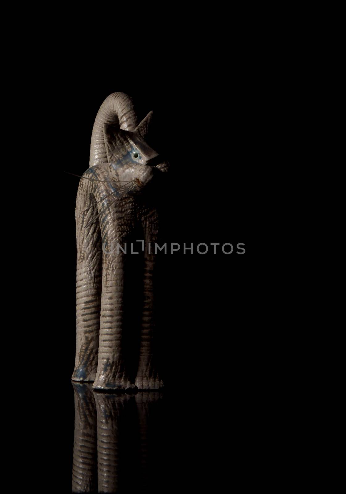 Cat figurine on black background