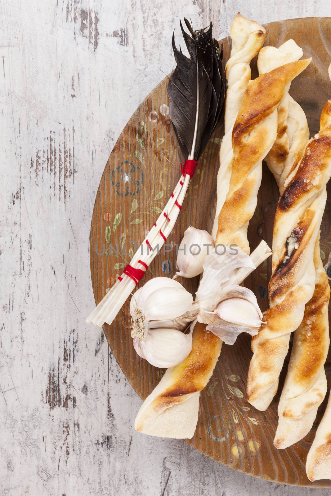 Delicious pizza breadsticks with garlic on white wooden background, top viw. Culinary italian eating. 
