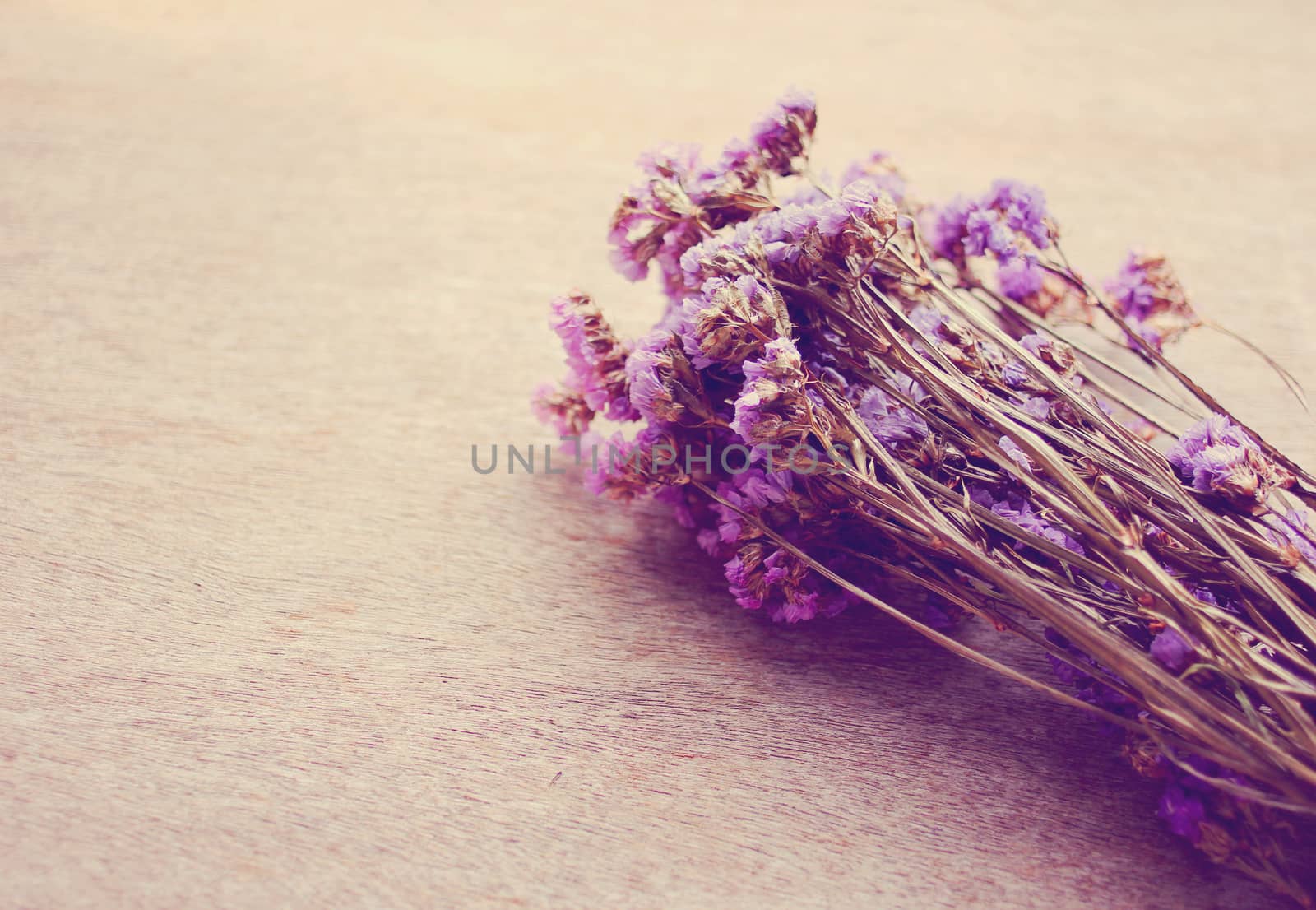 Statice flowers on wooden background by nuchylee