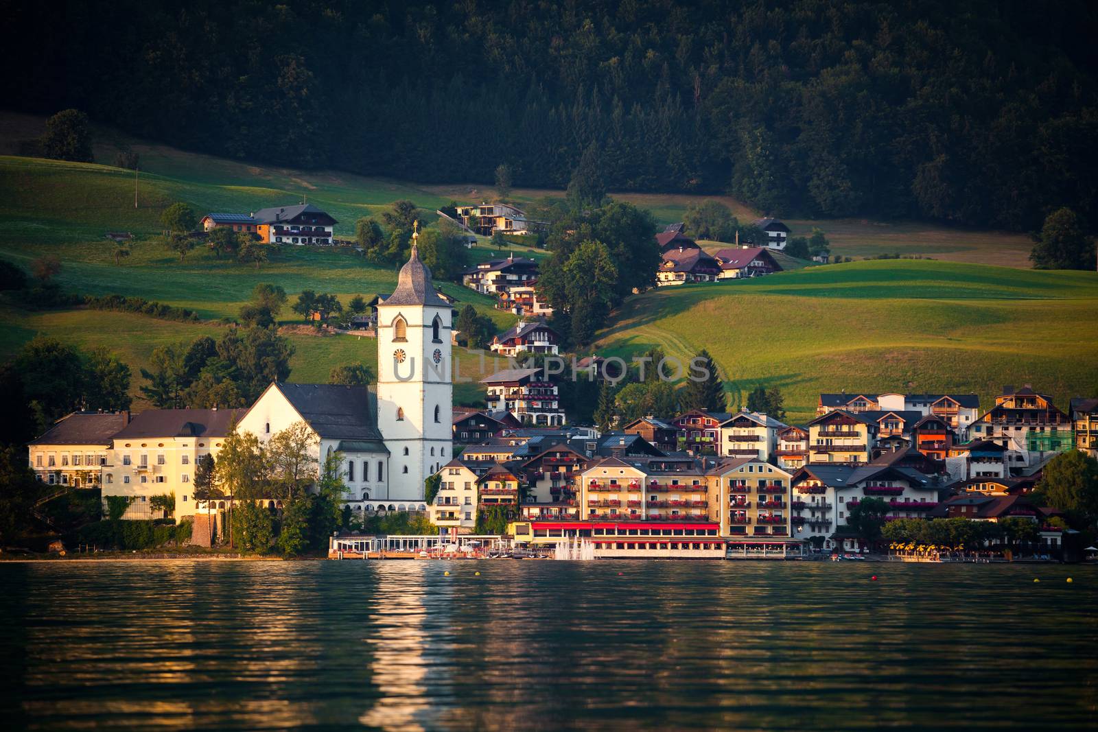 View of St. Wolfgang village waterfront at Wolfgangsee lake at sunset, Austria