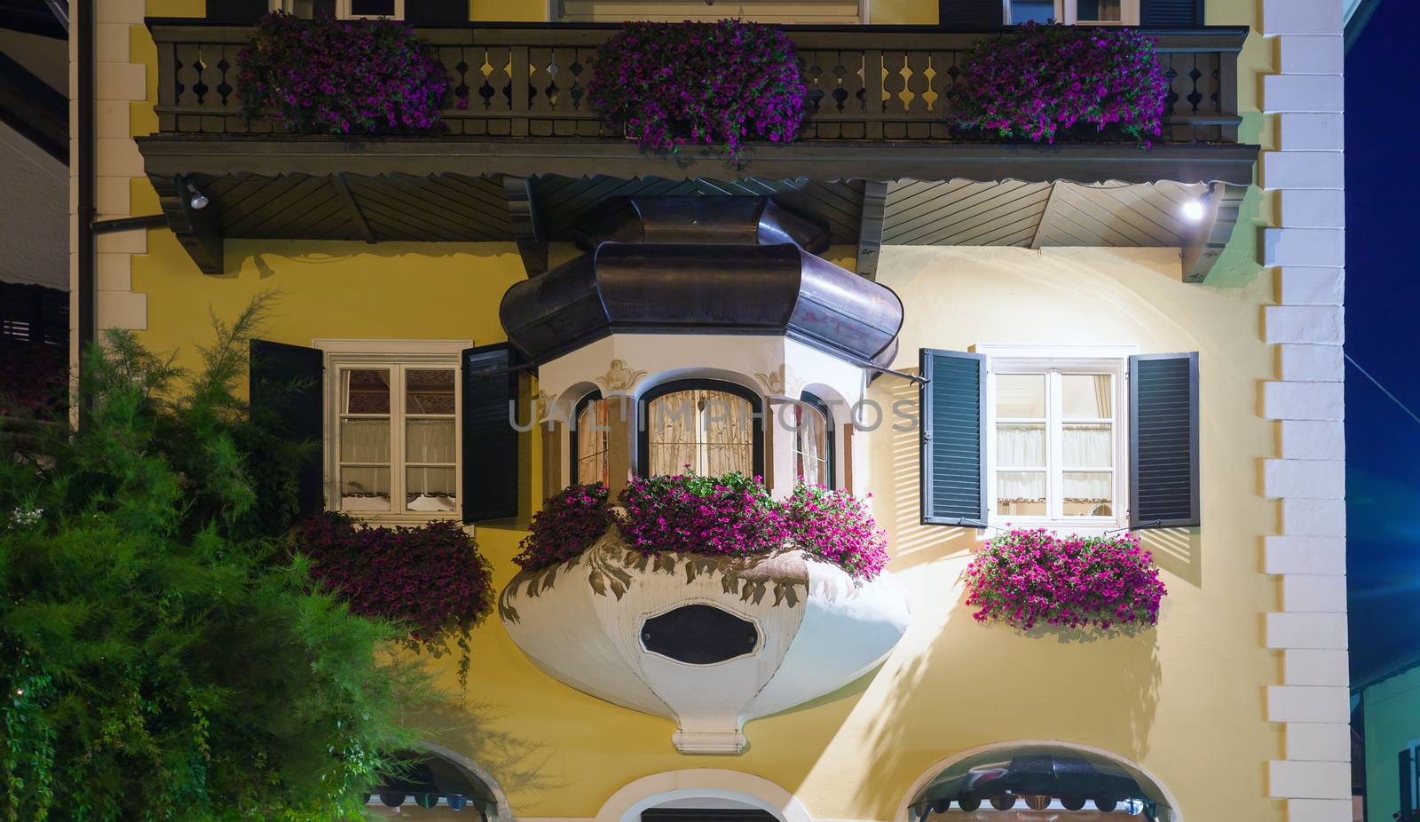 Typical Austrian guesthouse at night on Mozartplatz in St. Gilgen, Austria