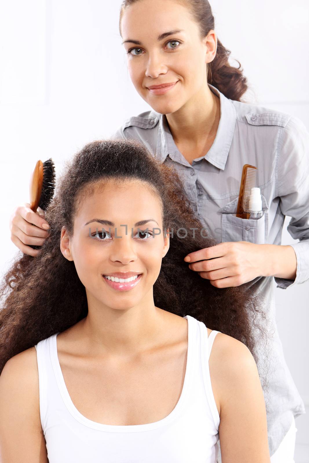 The dark-skinned woman in a hair salon