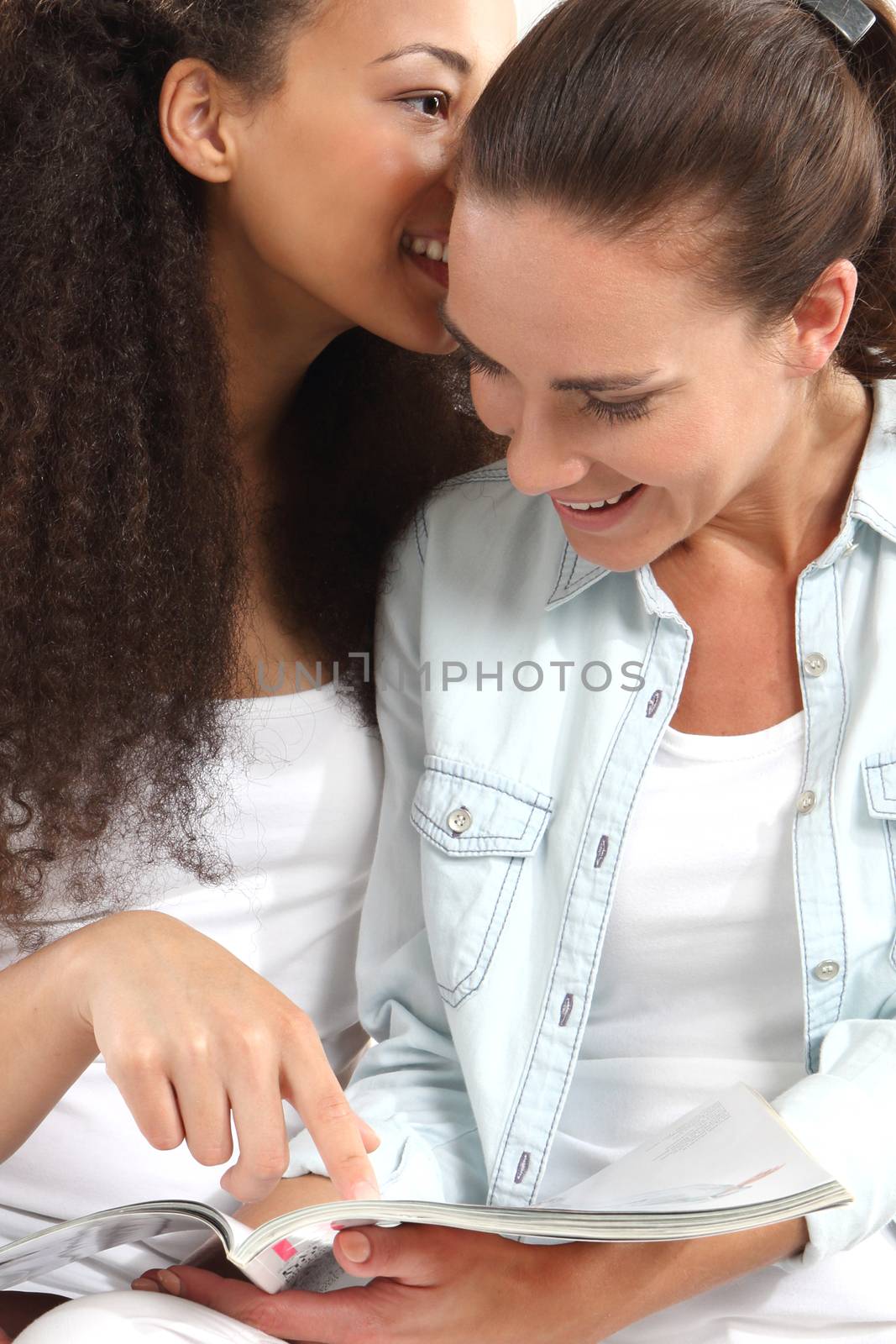 Two young women whisper in his ear.