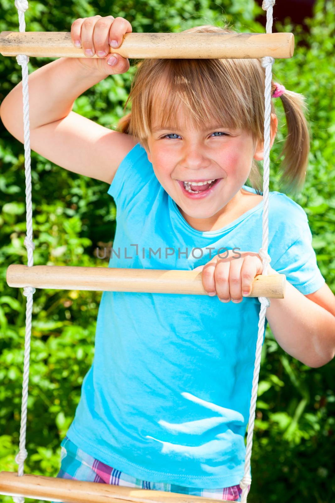 Happy child on a jungle gym by naumoid