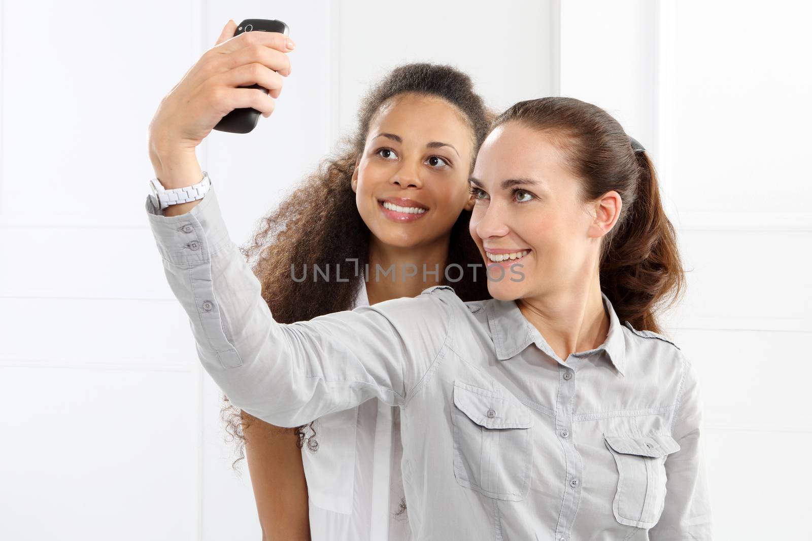 Two women take pictures with your phone