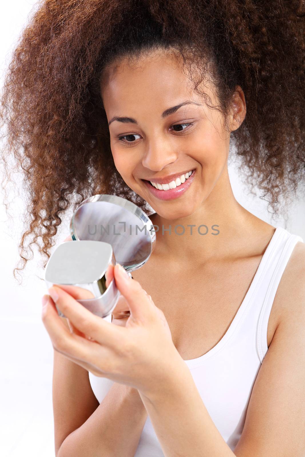 Young dark skinned girl smiling while looking under the microscope the face cream