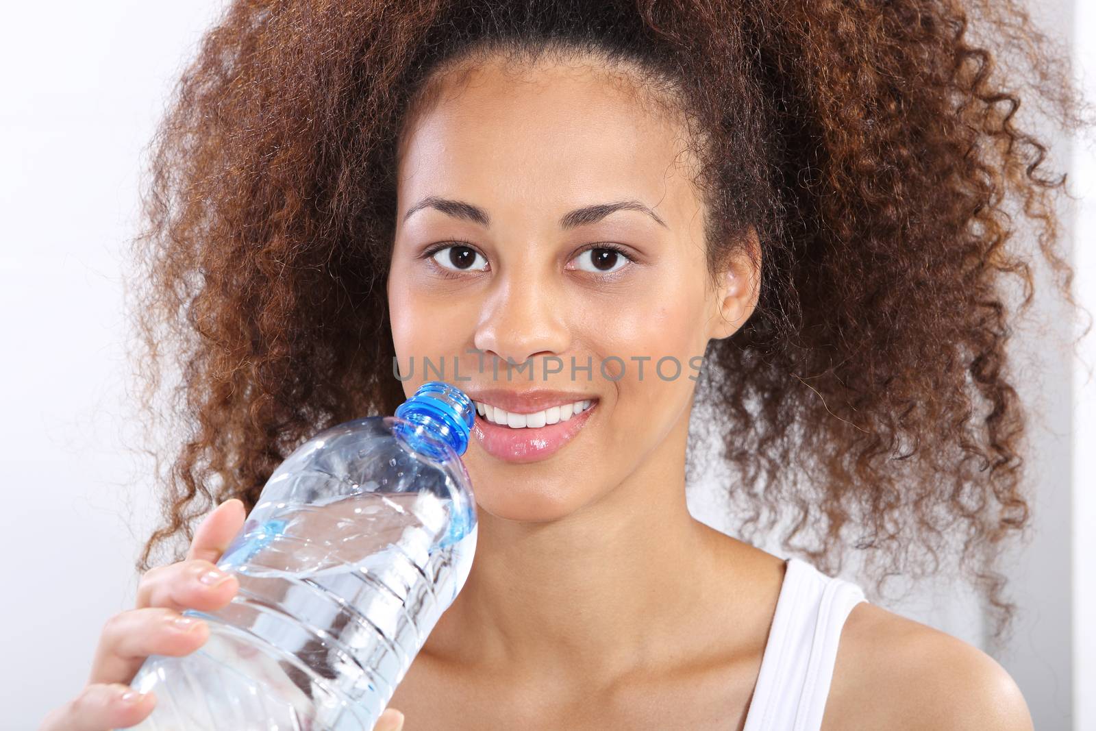 Mineral water, dark skinned girl with bottle of water