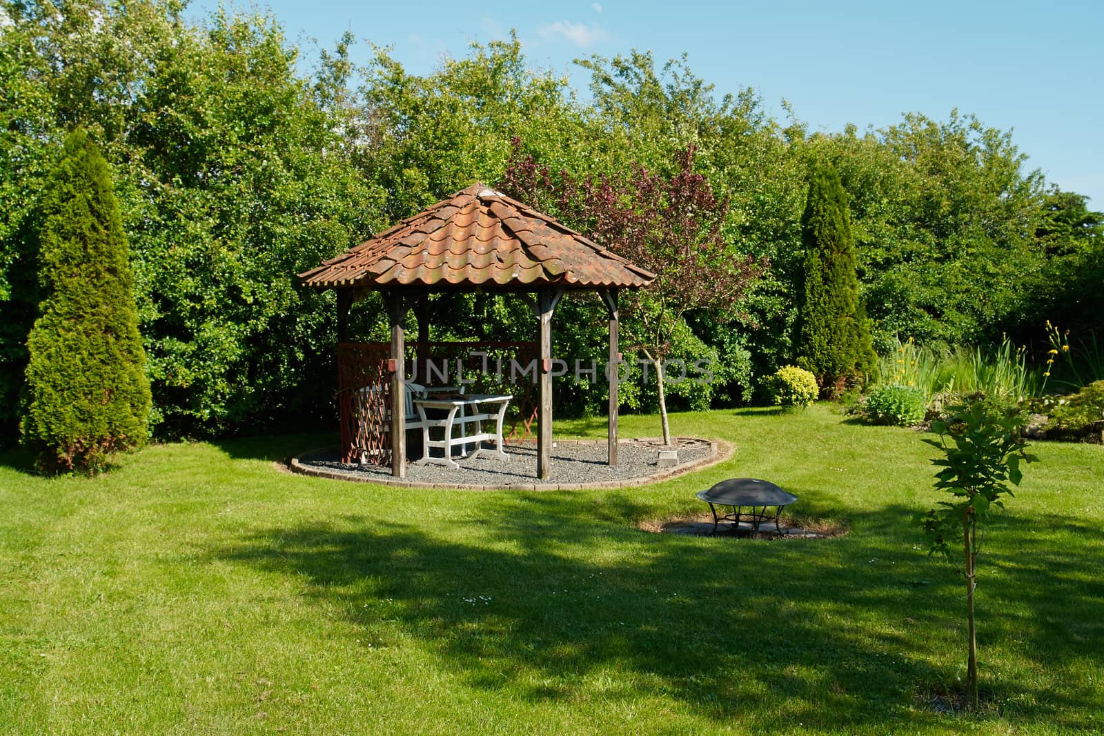   Beautiful decorative home garden yard gazebo pavilion in the summer                                  