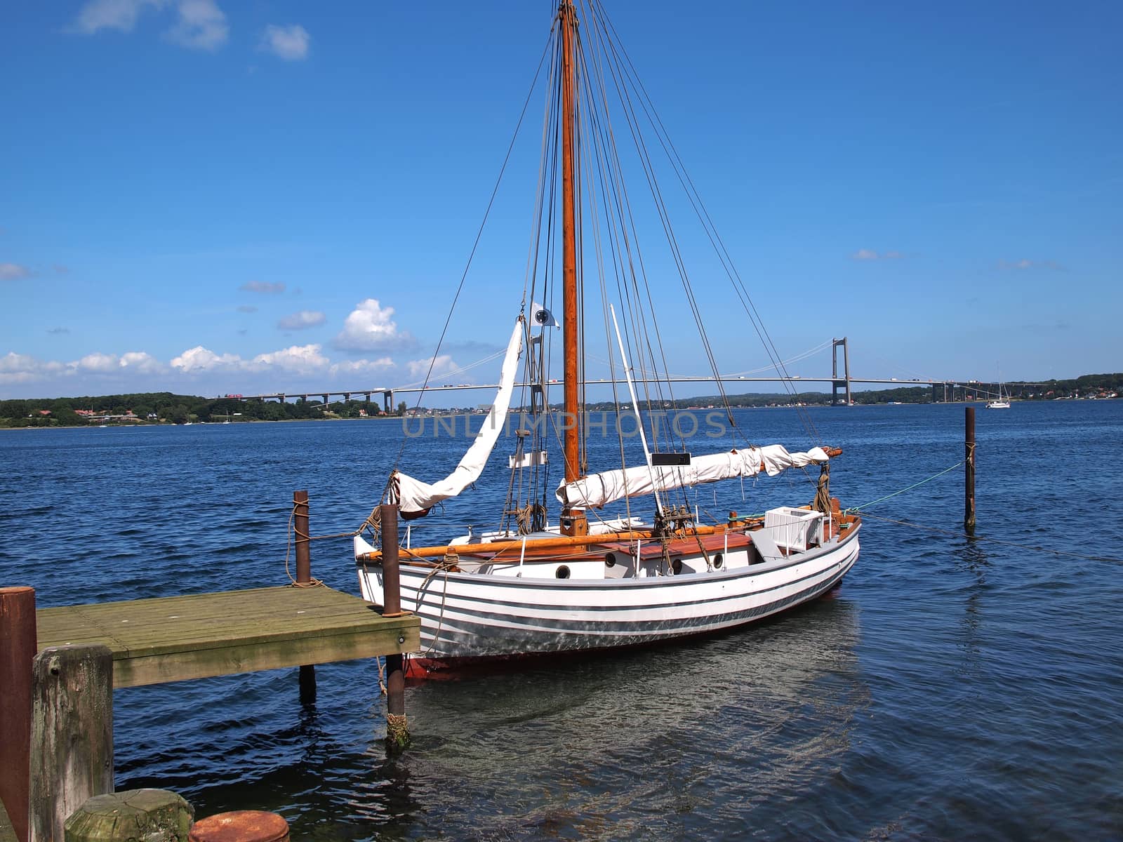 Old vintage traditional wooden sail boat in Middelfart Marina Denmark