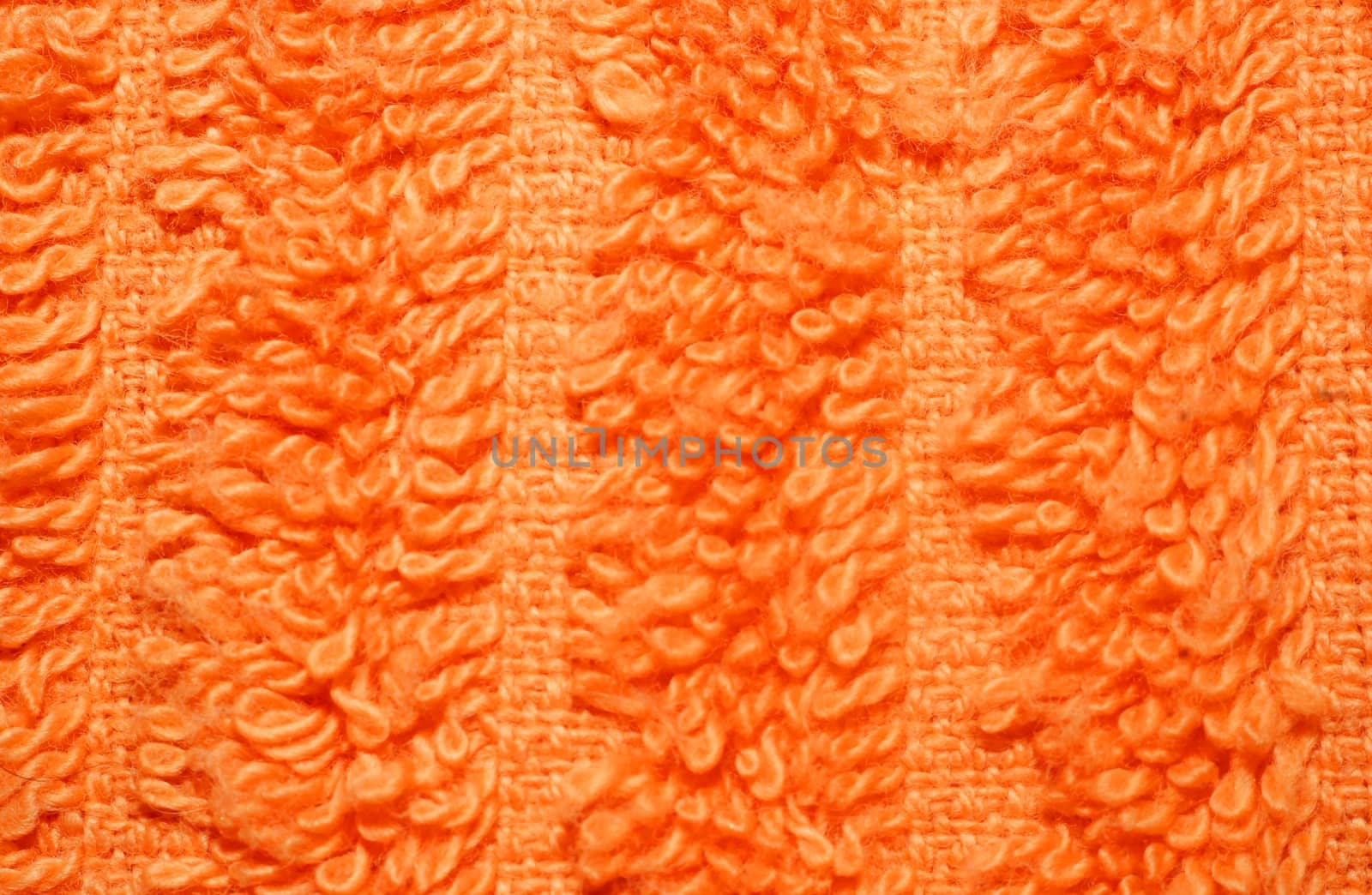  Texture of bright orange terry towels very closeup                              