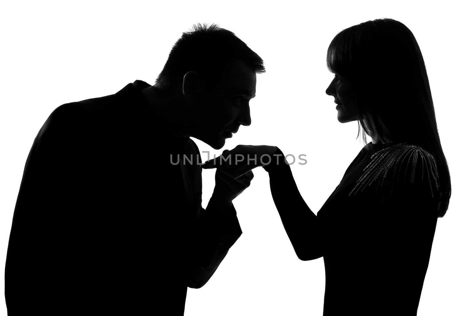 one  man kissing hand woman in studio silhouette isolated on white background