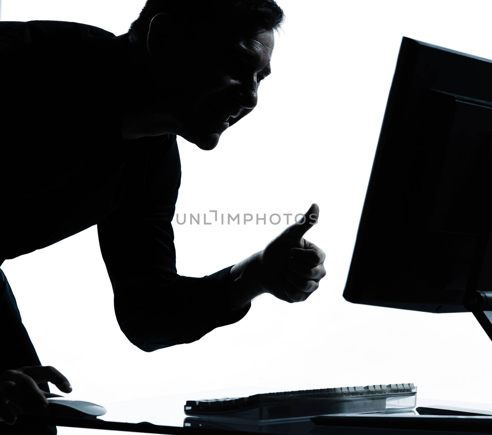 one  business man computing computer thumb up satisfied portrait silhouette in studio isolated on white background