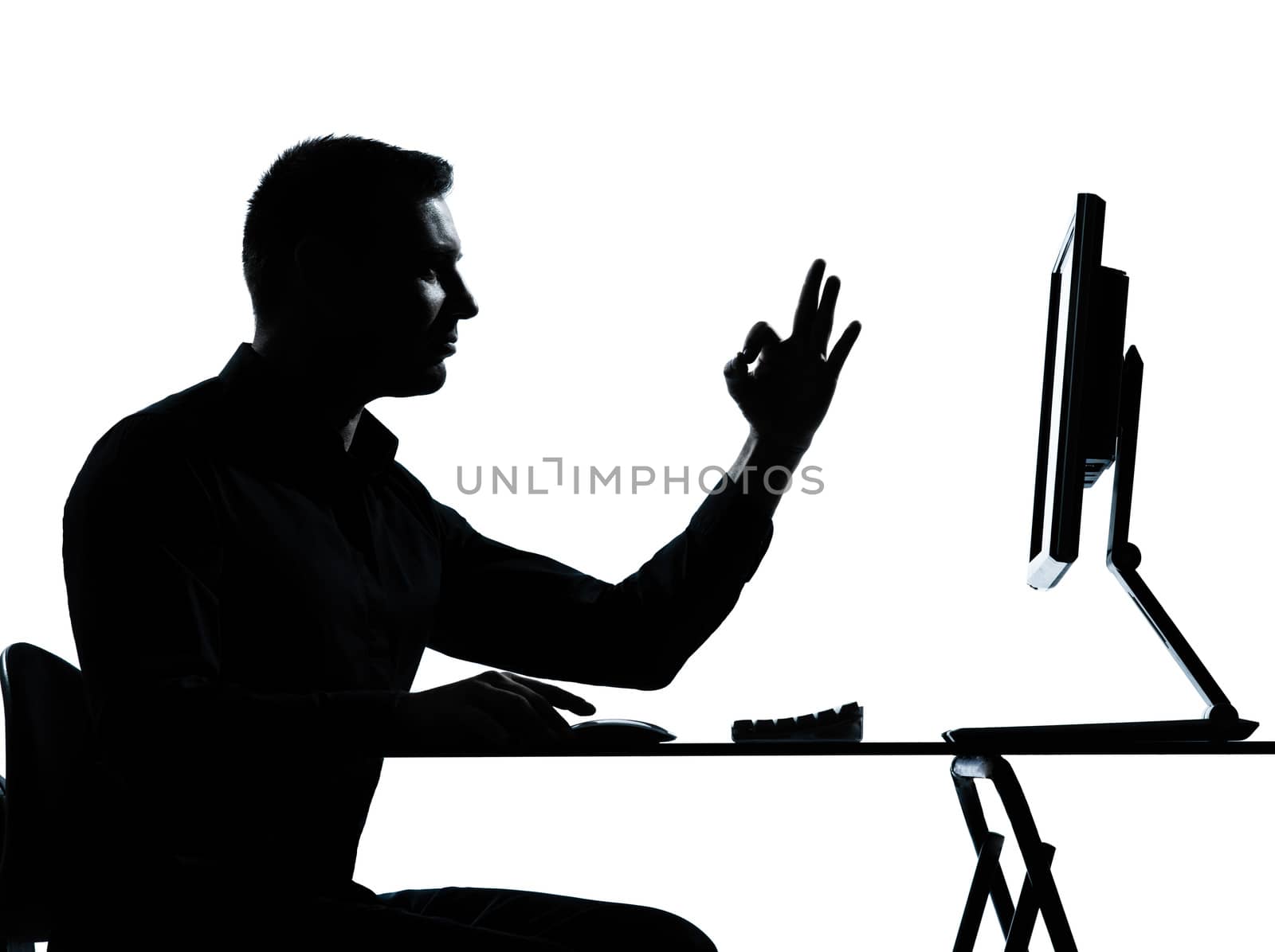 one  business man computer computing ok gesture silhouette in studio isolated on white background