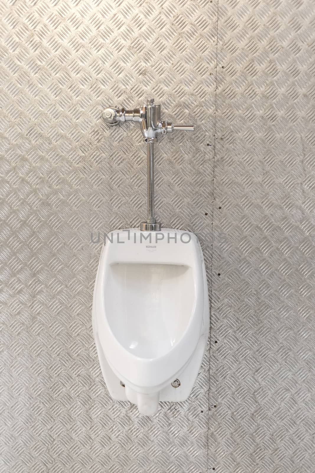 Man toilet with metal wall