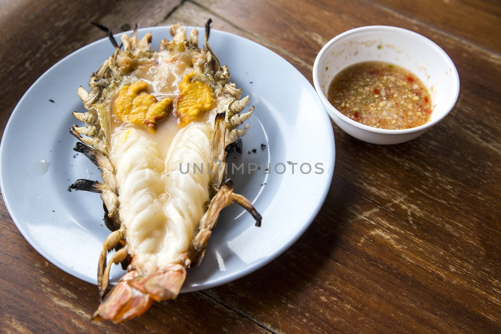 Big prawn on dish with spicy sauce