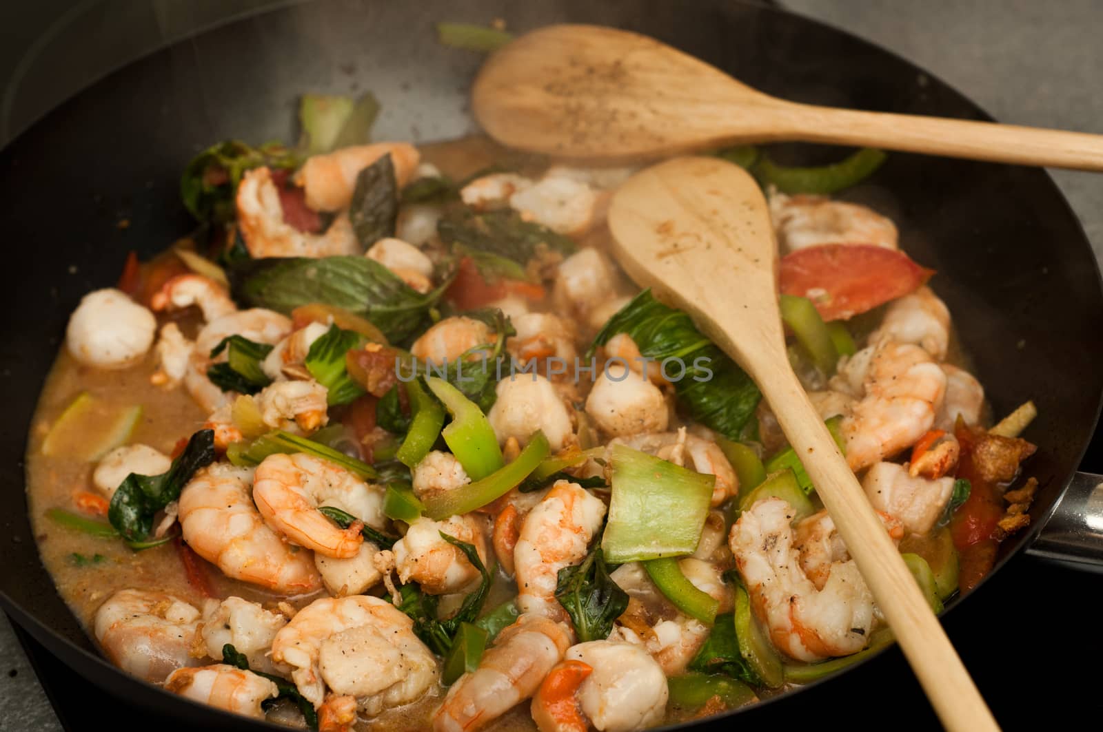 asian eating with wok closeup