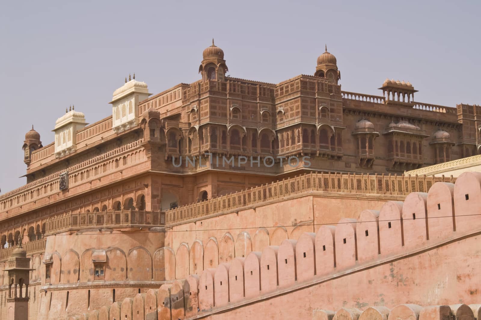 Red sandstone walls of Junagarh Fort enclosing exquisitely carved palace buildings. Bikaner, Rajasthan, India