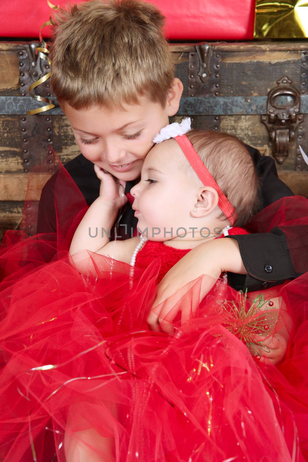 Young boy with his baby sister at christmas time