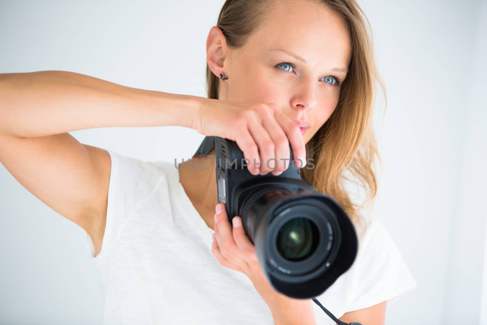 Pretty, female photographer with digital camera - DSLR by viktor_cap