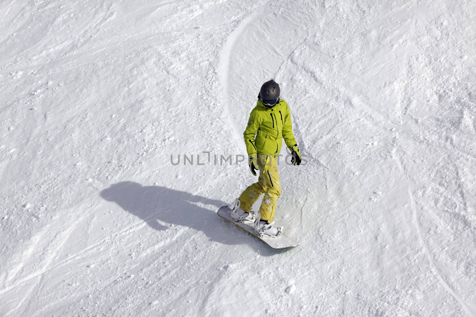 Snowboarder riding fresh powder snow