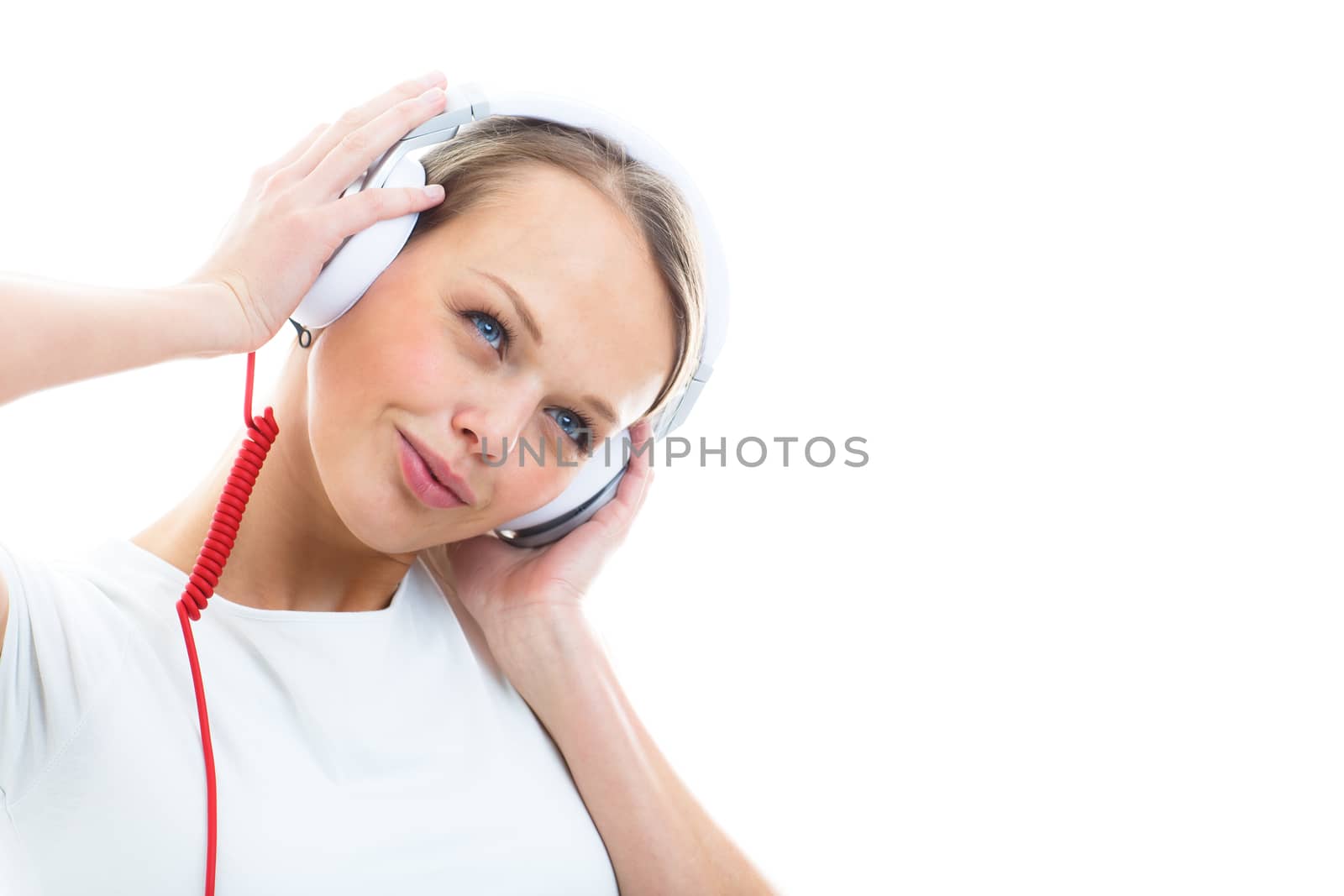 Pretty, young woman listening to her favorite music on hi-fi headphones, dancing, enjoying the tune, having a moment for herself
