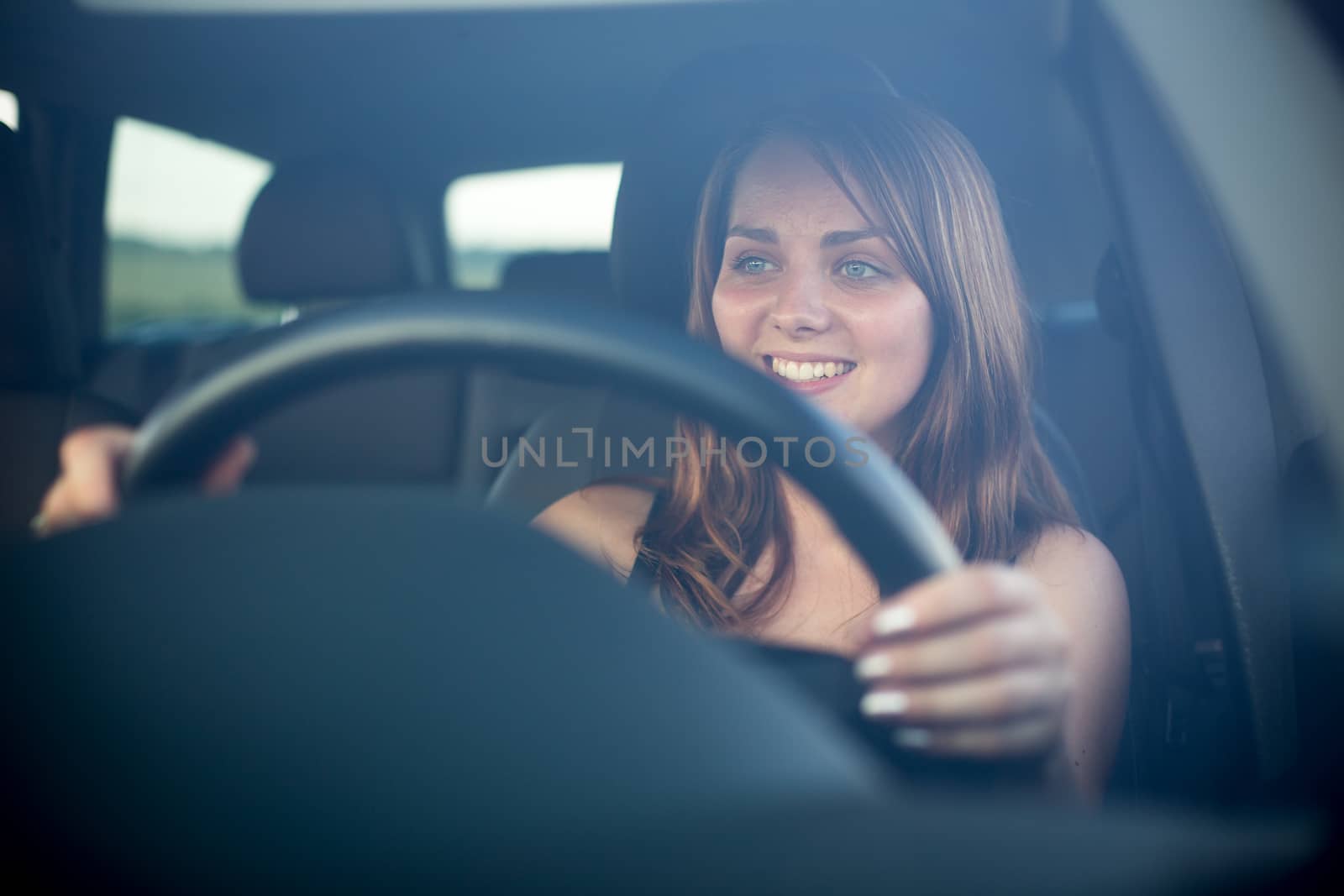 Cute teenager driving her brand new car