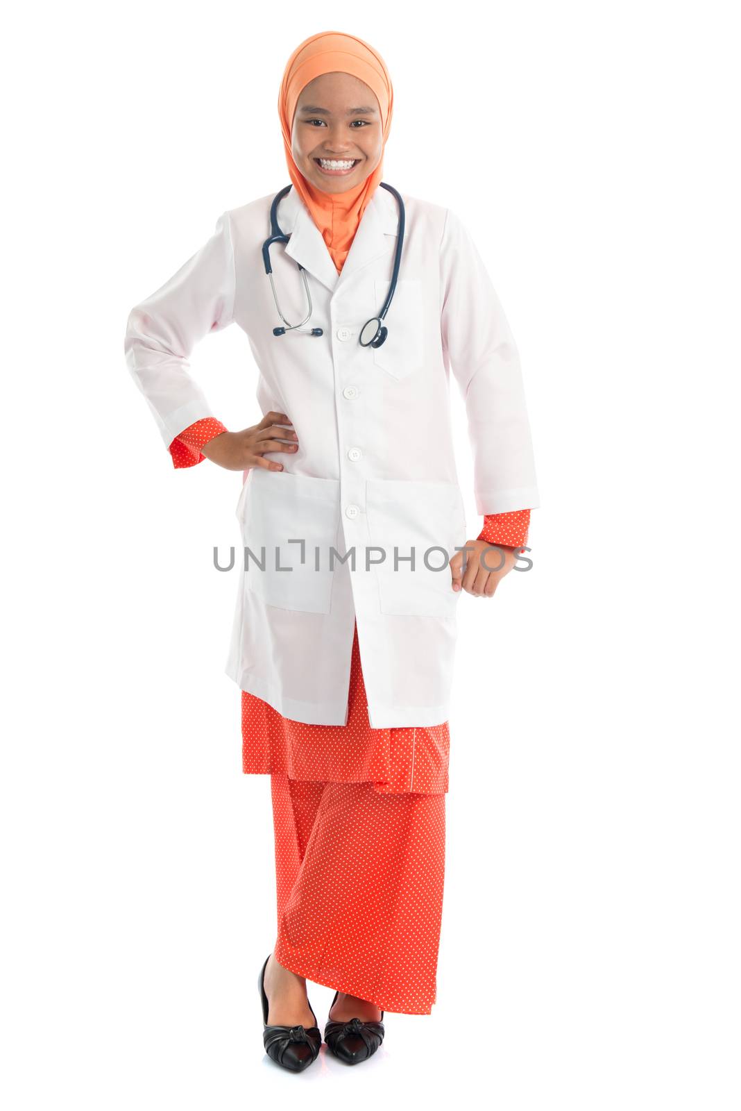 Full body young Muslim female doctor portrait, standing isolated on white background.