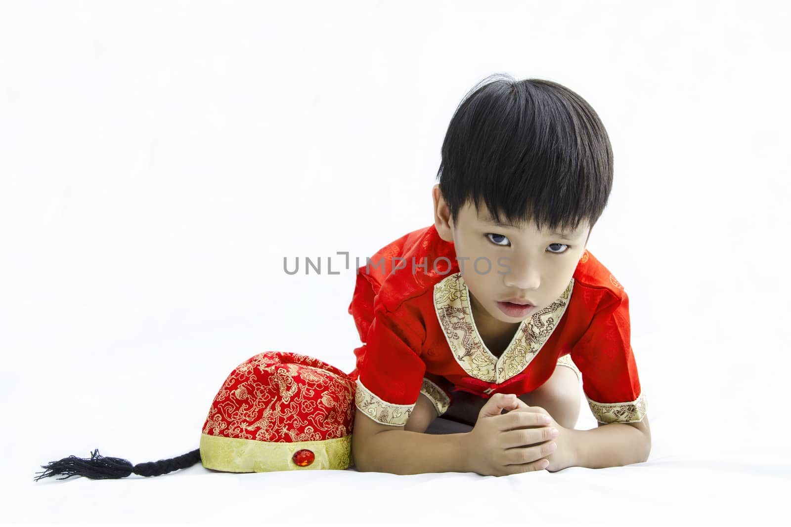 China boy in traditional Chinese red Tang suit greeting