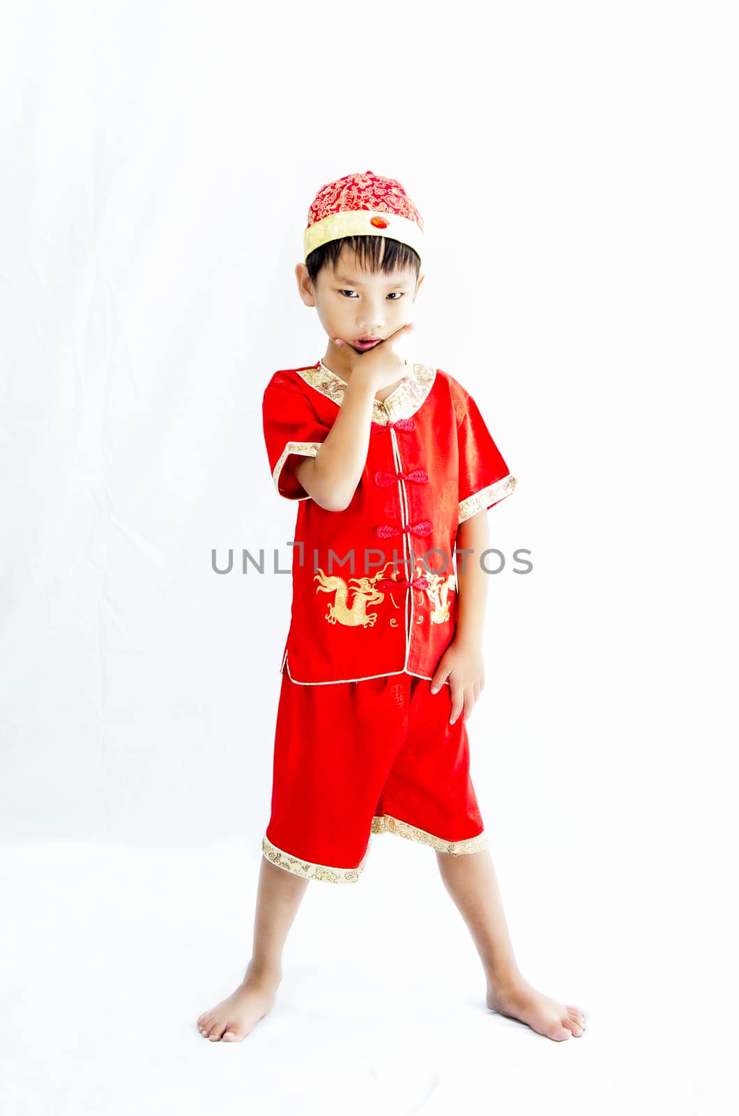 China boy in traditional Chinese red Tang suit greeting by Yuri2012