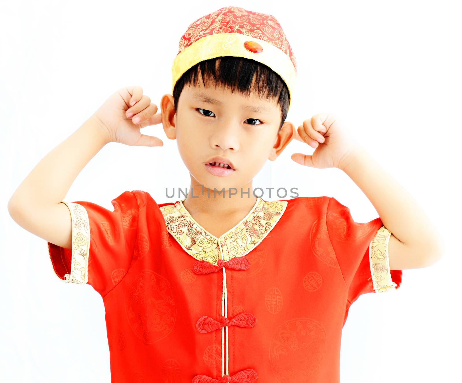 China boy in traditional Chinese red Tang suit greeting