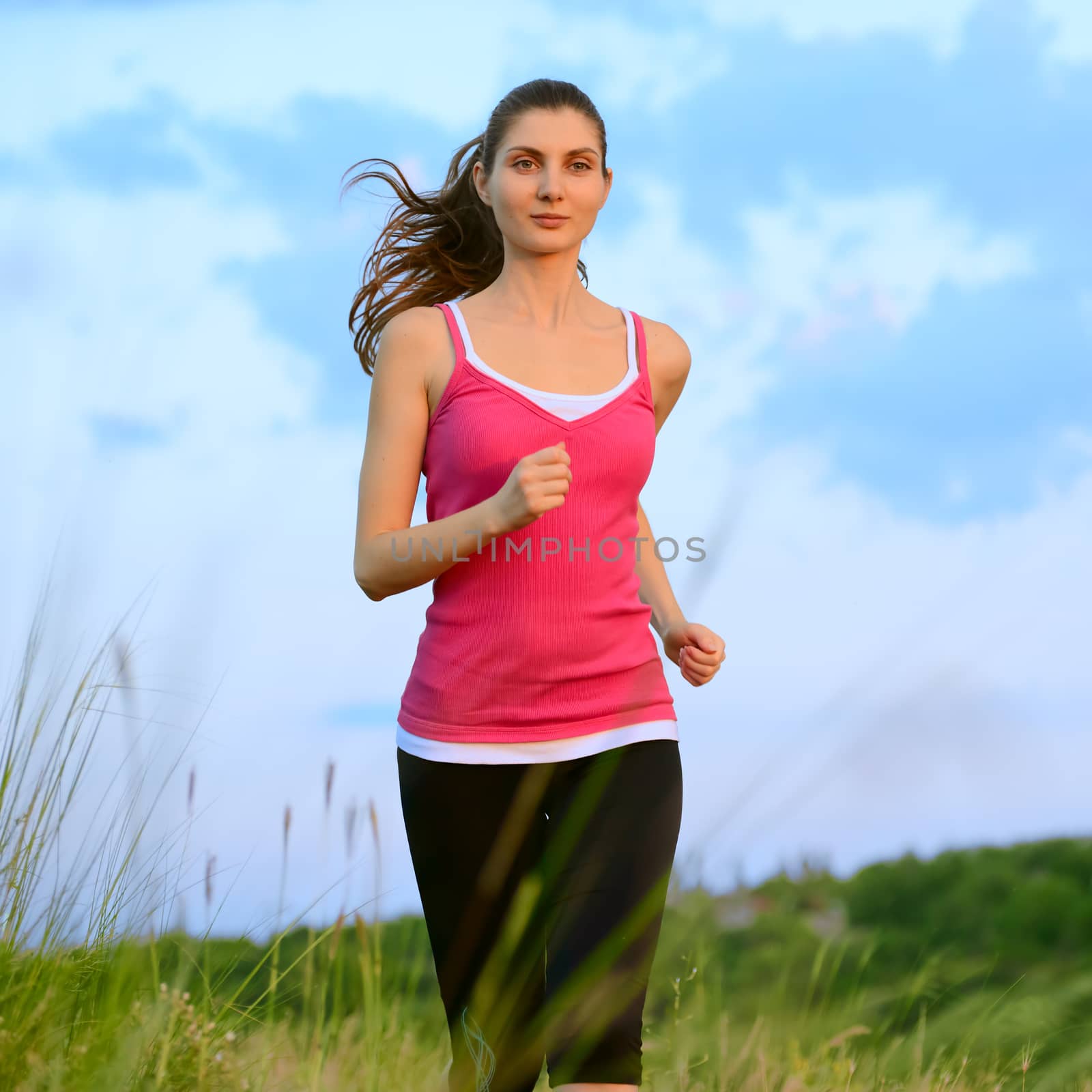 Young Beautiful Woman Running on the Mountain Trail in the Morning by maxpro