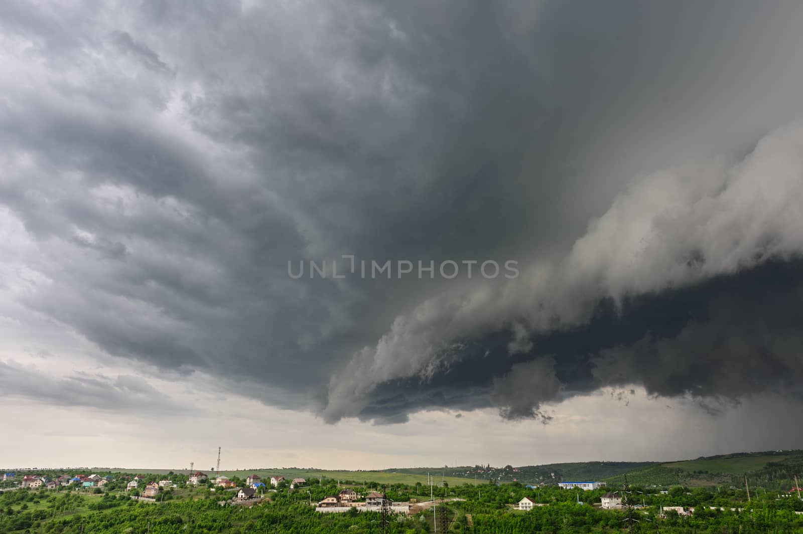 Beginning of the  storm with small tornado above the village